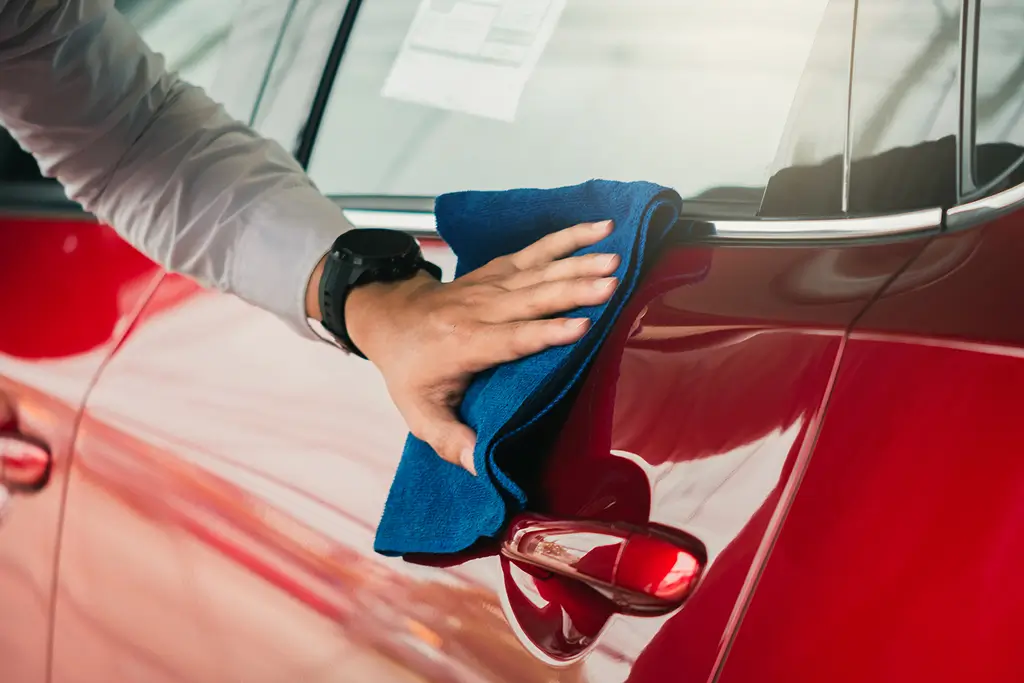 man polishing a car